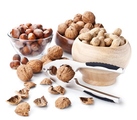 Still life with nuts and nutcracker on white