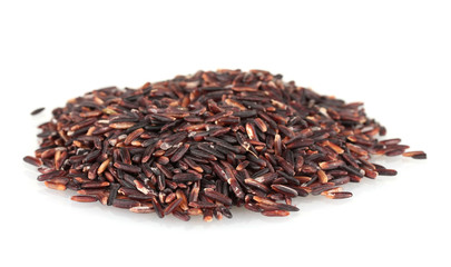 black  rice uncooked in a heap isolated on a white background