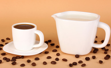 A cup of strong coffee and sweet cream on beige background