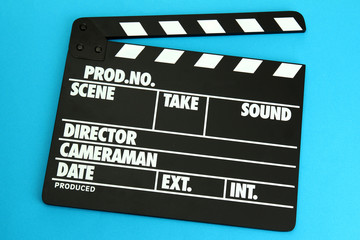 Fototapeta premium Movie production clapper board on color background