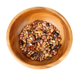 Beans in wooden bowl isolated on white