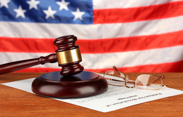 Divorce decree and wooden gavel on american flag background
