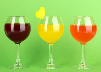Colorful cocktails on green background