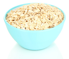 Blue bowl full of oat flakes isolated on white