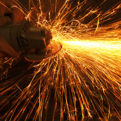 Worker making sparks while welding steel