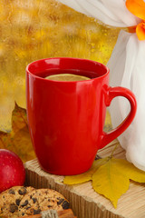 cup of hot tea and autumn leaves, on rain background