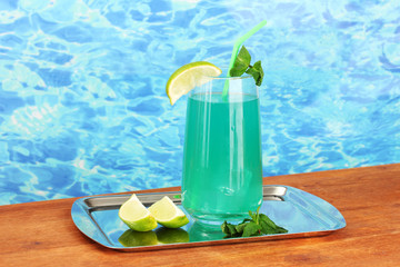 Cocktail on tray on blue background