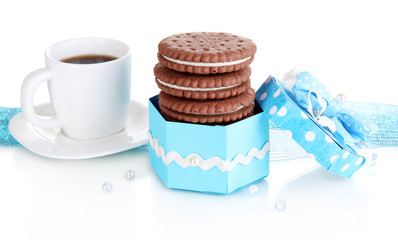 Chocolate cookies with creamy layer and cup of coffe isolated