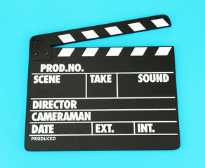 Movie production clapper board on color background