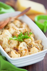Gratin of fennel and cauliflower with cheese, selective focus