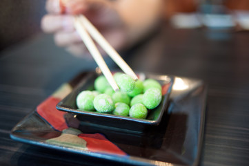 Close up of Wasabi Beans on Black Dish
