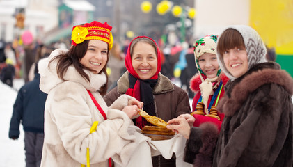People eating pancakes during  Maslenitsa