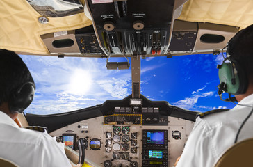 Pilots in the plane cockpit and sky