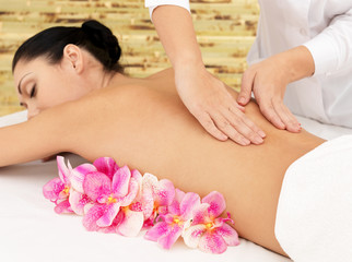 Woman on healthy massage of body in beauty salon