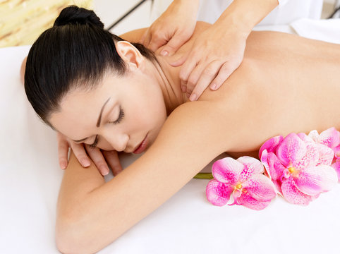 Woman on healthy massage of body in beauty salon