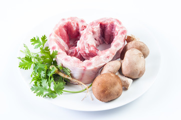 Raw pork ribs on a cutting board and vegetables