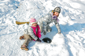 Fototapeta na wymiar Kids having fun in winter, children playing with snow