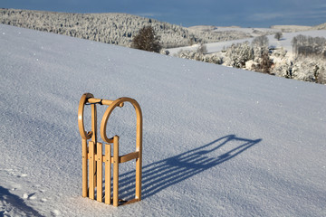 Holzschlitten im Schnee