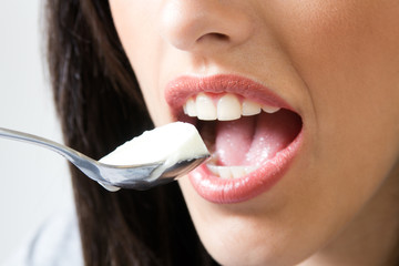 young woman at home eating yogurt