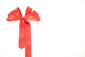 Shiny red satin ribbon on white background