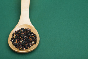 Black rice in wooden spoon