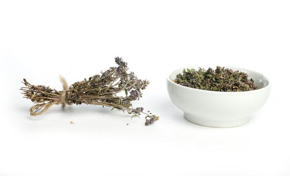 Dried thyme in a bowl and thyme twigs