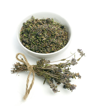 Dried thyme in a bowl and thyme twigs