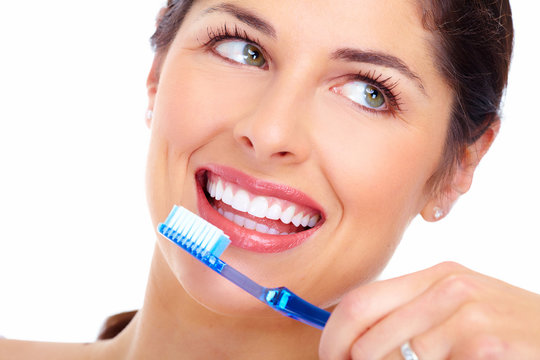 Beautiful woman smile with a toothbrush.