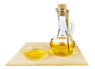Glass bottle of oil and saucer with oil