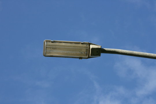 A rectangular street lamp, blue sky in the background