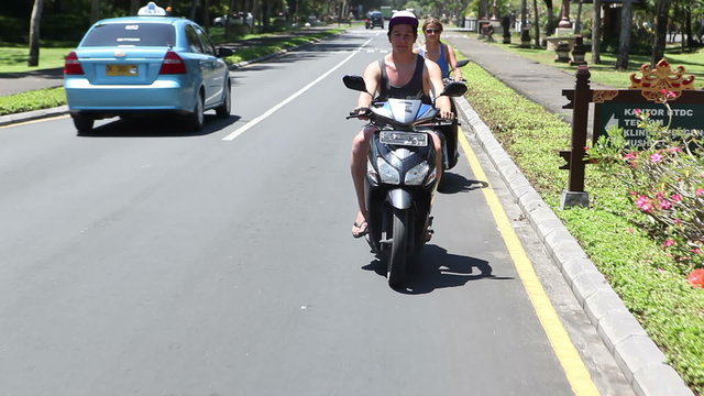 People driving on mopeds on street