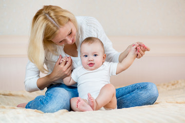Obraz na płótnie Canvas mother playing with baby boy