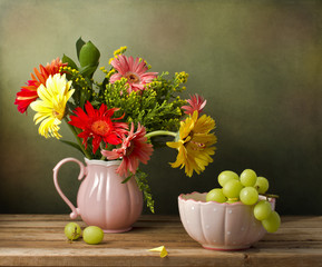 Still life with beautiful flower bouquet and green grapes © maglara