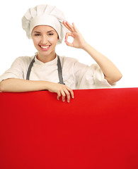 Chef woman holding a blank board and showing ok