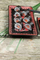 Sushi with a salmon on a wooden table