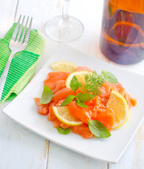 fresh salmon with lemon on the white plate