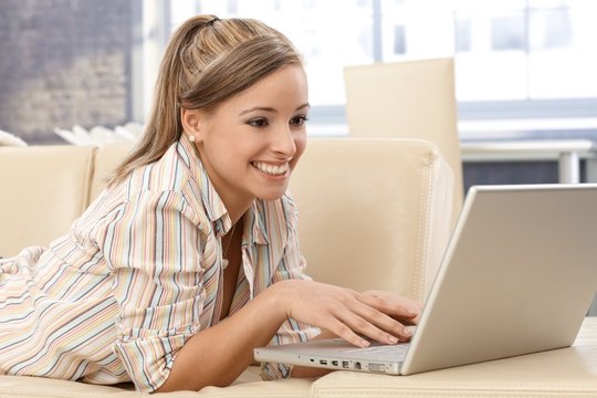 Attractive woman using laptop at home