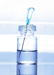 Transparent vial with a needle. Symbol of pharmacology, pharmacy