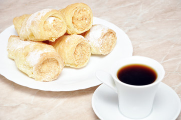Pastry rolls with cream and coffee