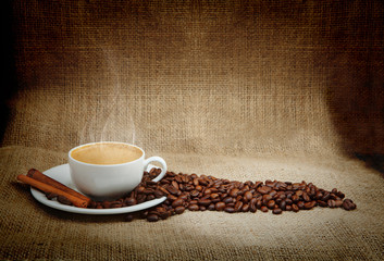 warm cup of coffee on brown background
