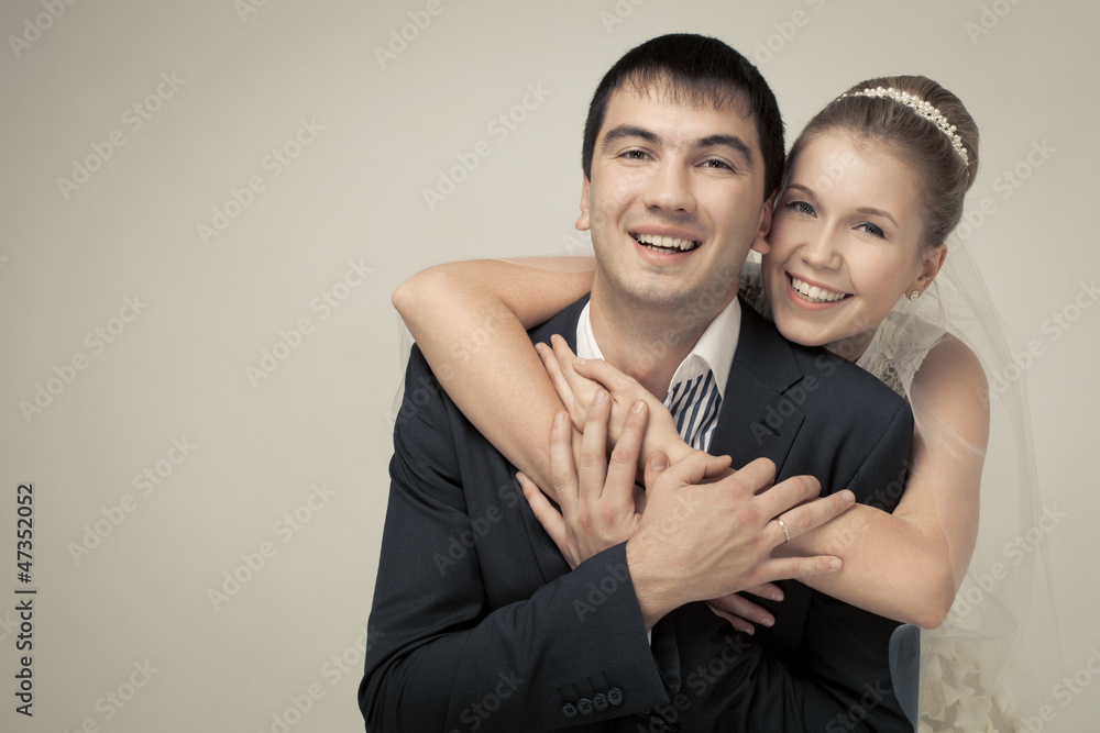 Wall mural gentle couple of lovers groom and bride. studio shooting at whit