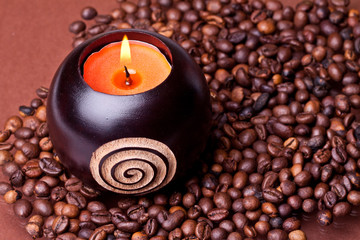 candle on a background coffee beans heart