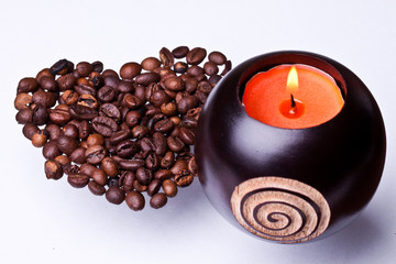 candle on a background coffee beans heart
