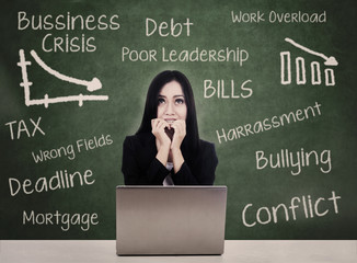 Business woman with laptop fears debt crisis