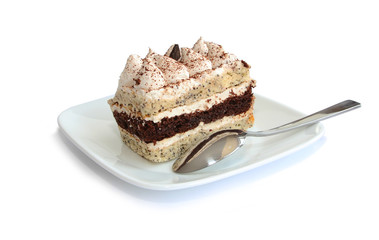 whipped cream cake with spoon on white plate isolated on white