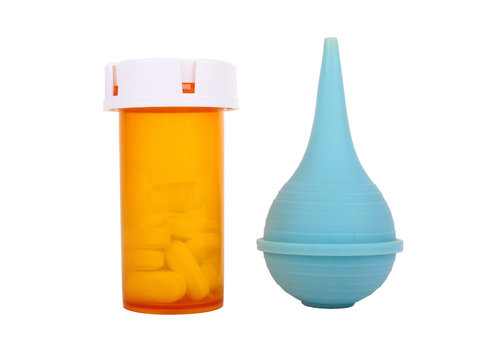 blue medical enema and pill bottle isolated on white