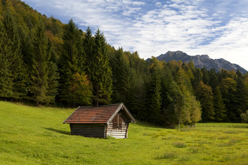 wooden alpine hut in autumn