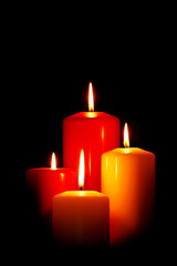 Four Christmas candles on black