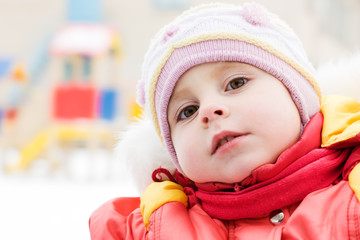 Beautiful happy kid in the red jacket