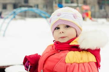 Beautiful happy kid in the red jacket